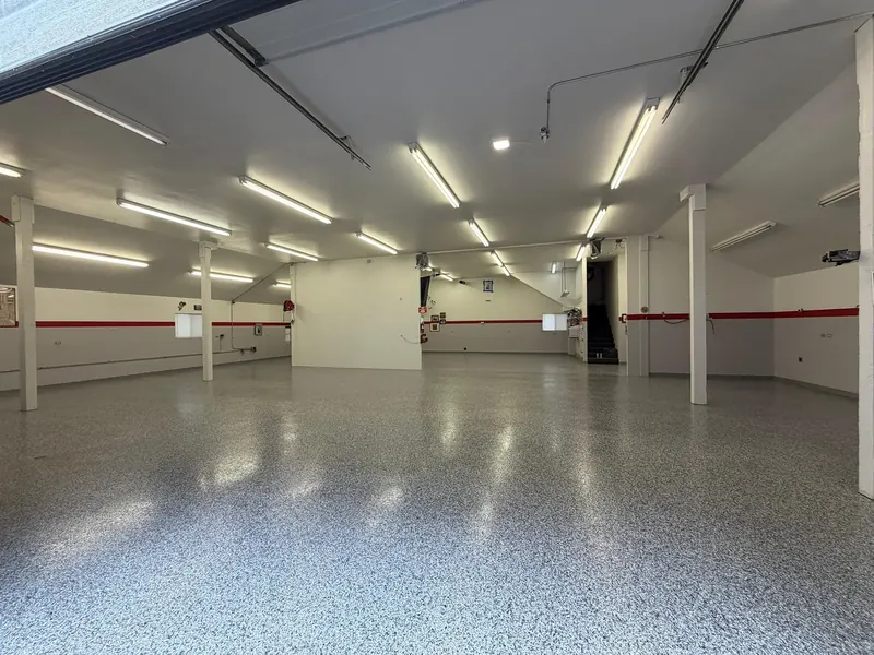 Large commercial facility with high-gloss polyaspartic floor coating installed by Rhino Coatings